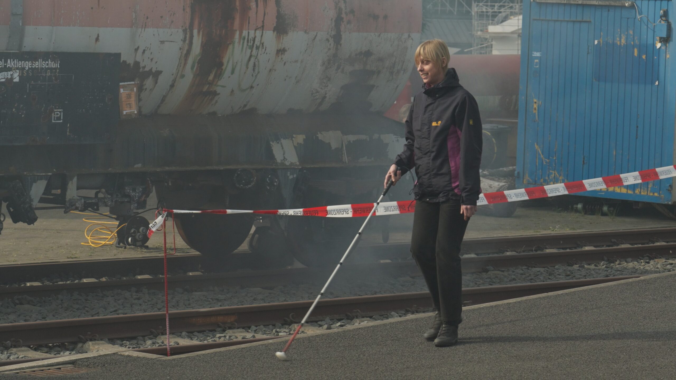 A blind participant is walking with her walking stick at the incident site